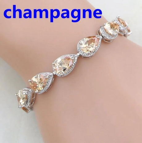 Bracelet with champagne-colored gemstones on a wrist, labeled 'champagne'.