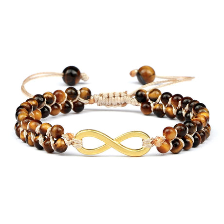 Set of tiger eye beaded bracelets with gold infinity symbol on a white background