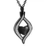 Black heart-shaped pendant with silver accents on a white background
