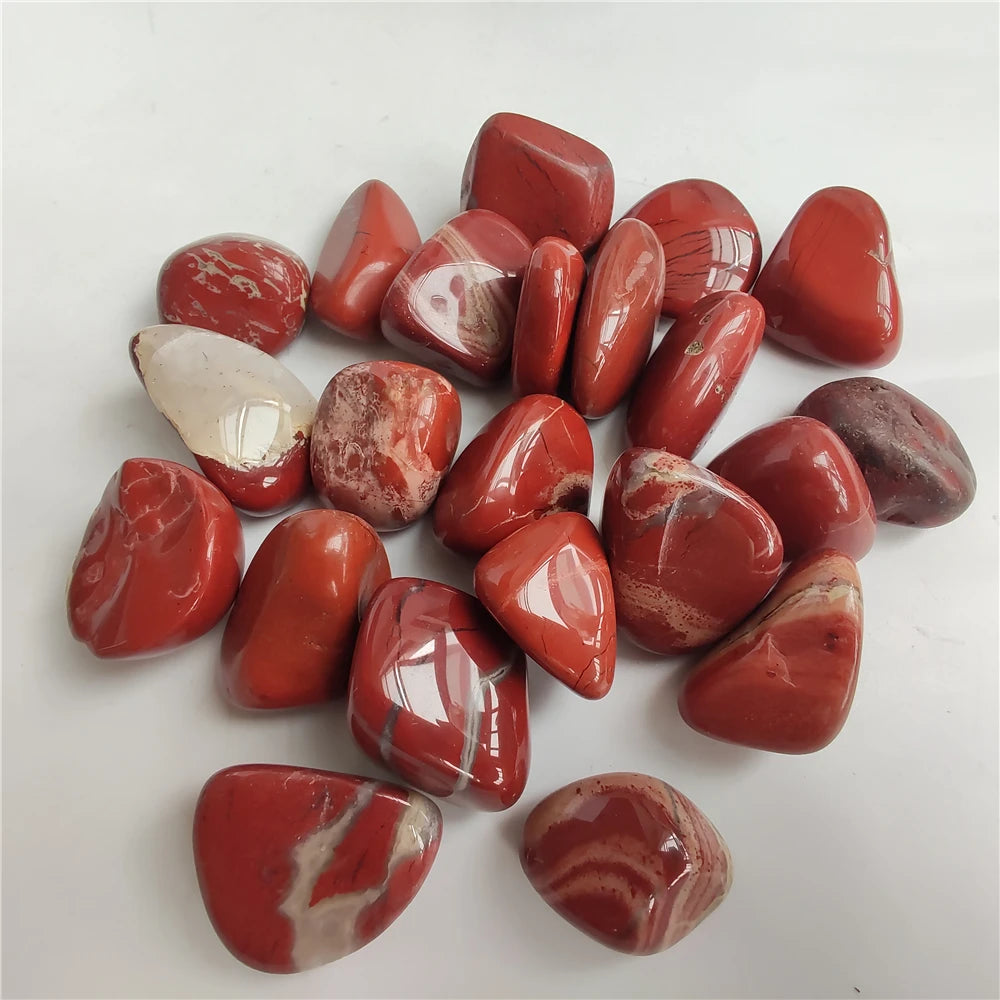 Collection of red marbled stones on a white background