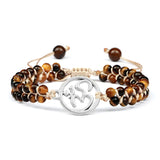 Set of tiger eye beaded bracelets with a silver OM symbol charm on a white background