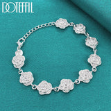Silver floral bracelet on a teal background with 'Doteffil' branding.