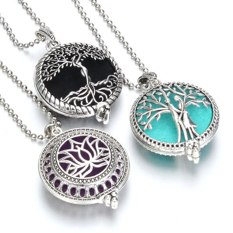 Three round pendants with tree designs on a white background