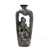 Decorative vase with a mountain and waterfall design on a white background