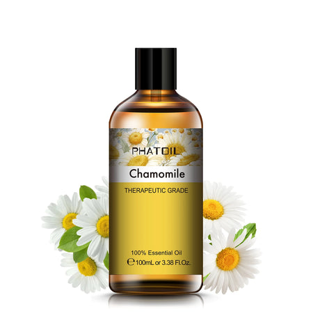 Bottle of PhatOil Chamomile essential oil with chamomile flowers on a white background