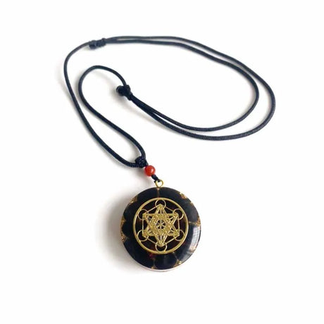 Necklace with a black pendant featuring a gold symbol on a white background