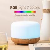 Aroma diffuser with RGB light feature on a wooden surface.