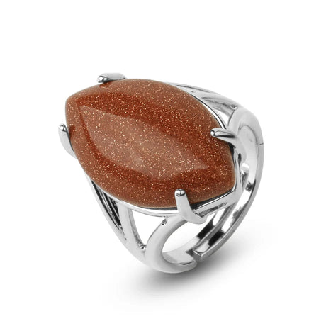 Silver ring with a large brown stone on a white background