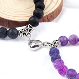 Bracelet with black beads and purple gemstones on a wooden surface