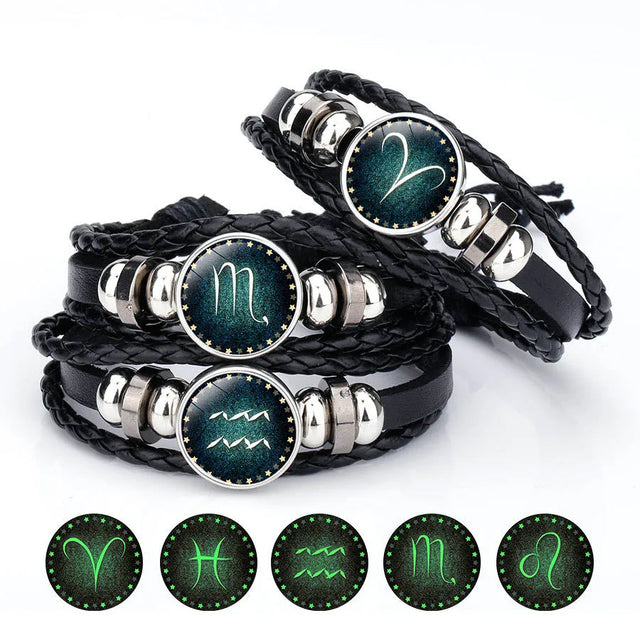 Set of zodiac symbol bracelets with glowing icons on a white background