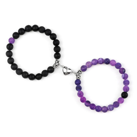 Black and purple beaded bracelets with silver clasp on a white background