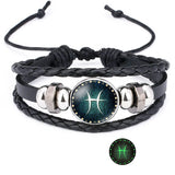 Black braided leather bracelet with silver accents and a central circular design on a white background.