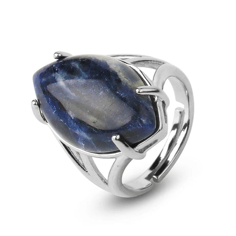 Silver ring with a large blue stone on a white background