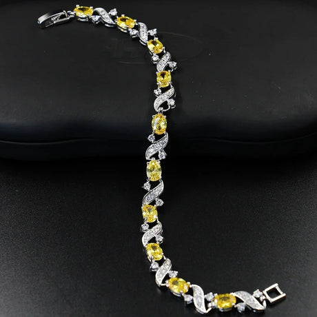 Bracelet with yellow gemstones and silver design on a black background