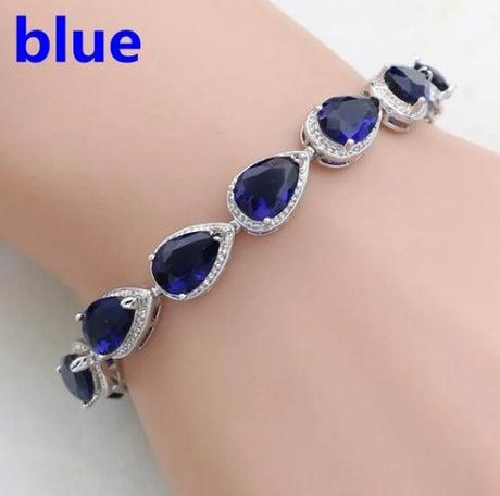Blue gemstone bracelet on a wrist with 'blue' text above