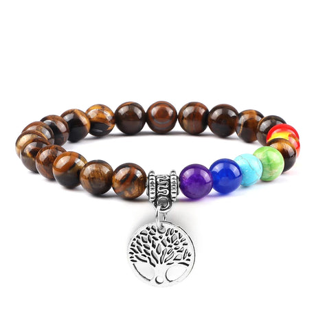 Multicolored beaded bracelet with a silver tree of life charm on a white background