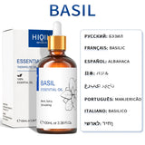 Basil essential oil bottle with dropper and packaging on a white background