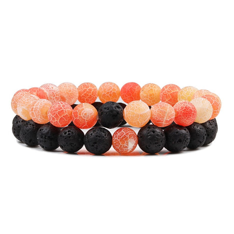 Two beaded bracelets with orange and black beads on a white background