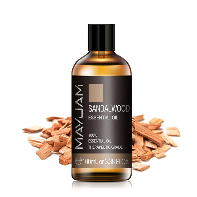 Sandalwood essential oil bottle with sandalwood pieces on a white background