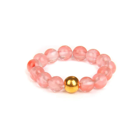 Pink beaded bracelet with a gold bead on a white background