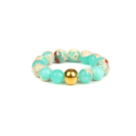 Beaded bracelet with turquoise, beige, and gold beads on a white background