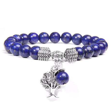 Blue beaded bracelet with silver tree charm on a white background