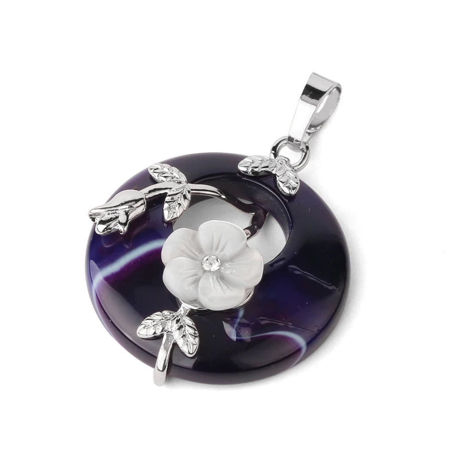 Purple agate pendant with silver floral design on a white background