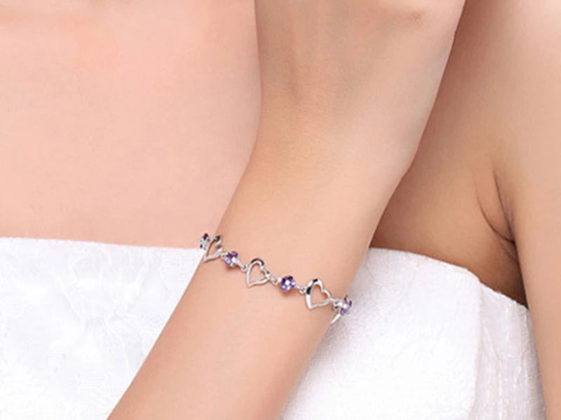 Bracelet with heart designs on a wrist, ZDADAN brand visible, 925 silver stamp.