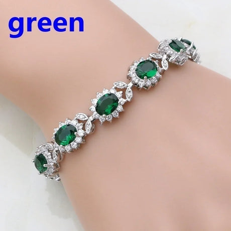 Silver bracelet with green gemstones on a mannequin wrist, labeled 'green'.