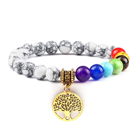 Multicolored beaded bracelet with a gold tree of life charm on a white background