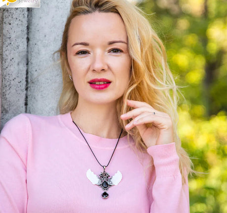 Woman wearing a necklace with a blurred outdoor background