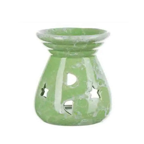 Green glass oil burner with star cutouts on a white background