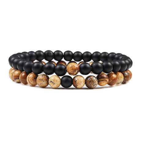 Stack of black and brown beaded bracelets on a white background