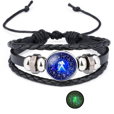 Black braided leather bracelet with silver accents and a blue astrological symbol charm on a white background.