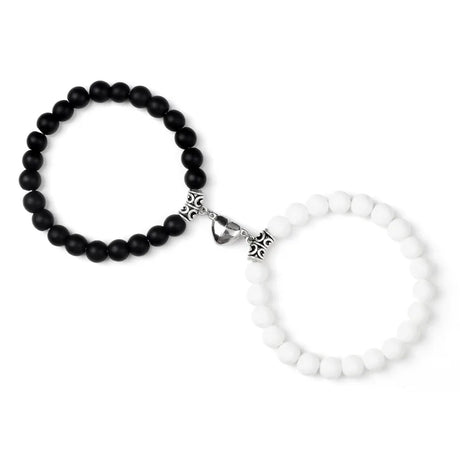 Black beaded bracelet with silver clasp and white beaded bracelet with silver clasp on a white background