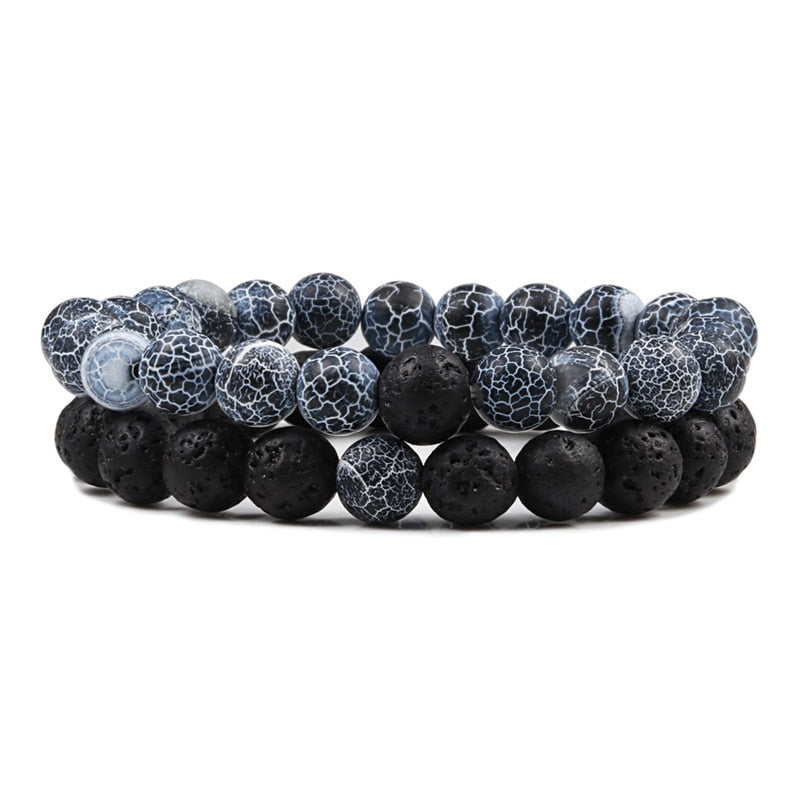 Set of black and gray beaded bracelets on a white background
