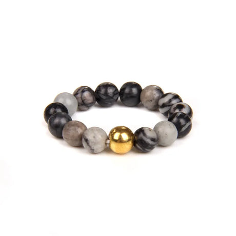 Bracelet with black, gray, and gold beads on a white background