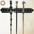 Wand holder with three decorative wands on a white background