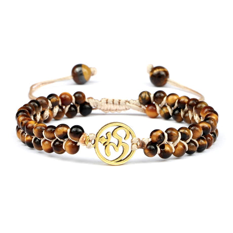 Set of tiger eye beaded bracelets with a gold charm on a white background