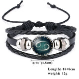 Black braided leather bracelet with a astrological sign charm on a white background
