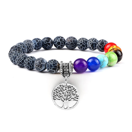 Multicolored beaded bracelet with a silver tree of life charm on a white background