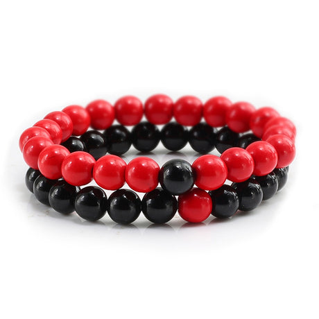 Two red and black beaded bracelets on a white background