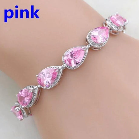 Pink bracelet with teardrop-shaped crystals on a white background
