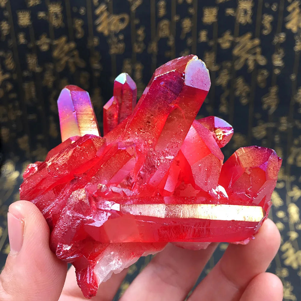 Red crystal formation held in a hand with a blurred background