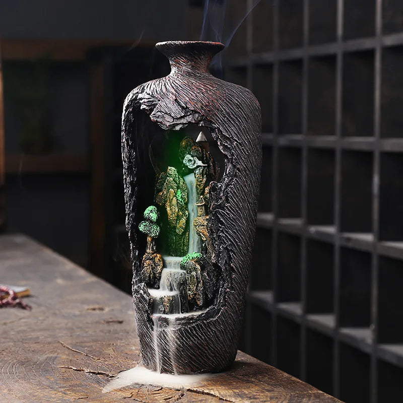 Decorative vase with a miniature landscape inside, resembling a fairy tale scene.