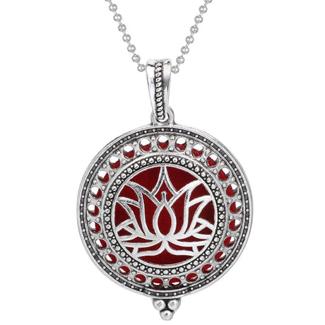 Silver pendant with red accents on a white background