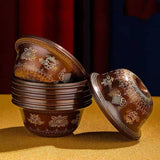 Decorative wooden containers with intricate carvings on a yellow surface