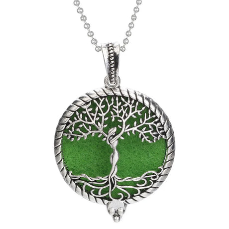 Silver pendant with green center and tree design on a white background