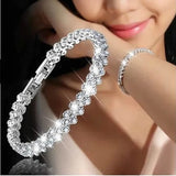 Silver bracelet with clear stones on a blurred background