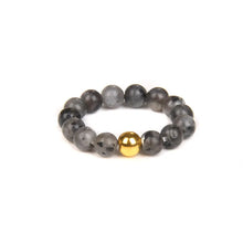 Beaded bracelet with a gold focal bead on a white background